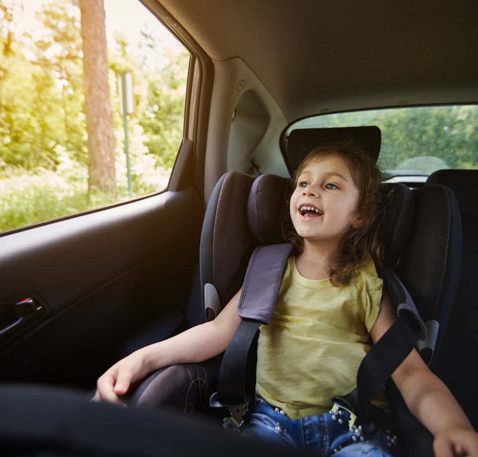 safe-movement-children-car-happy-girl-child-car-seat-wearing-seatbelt-while-traveling-by-car.jpg